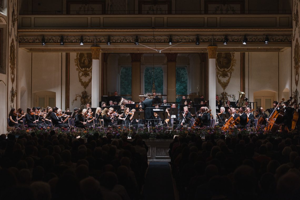 Orchester spielt im Goldenen Saal des Wiener Musikvereins vor Publikum.